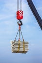 The crane lifts a heavy load on a hook