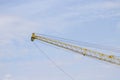 Crane lifts old yellow with blue sky Royalty Free Stock Photo