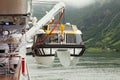 Crane lifts passengers boat to big liner Royalty Free Stock Photo