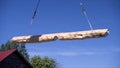 Crane lifts timber on construction site. Clip. Construction process with lifting of heavy beams by means of crane. Crane