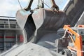 Crane loading cargo ship with gravel Royalty Free Stock Photo