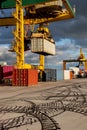 A crane loading container boxes at a busy commercial dock Royalty Free Stock Photo