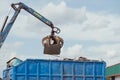 Crane-loading scrap grabber old metal at industrial metal recycling plant Royalty Free Stock Photo