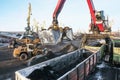 Crane manipulator unloads coal at the seaport.