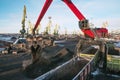 Crane manipulator unloads coal at the seaport.