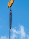 Crane metal chain and hook against blue sky Royalty Free Stock Photo