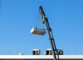 Crane moves large electrical component for radio wave repeater