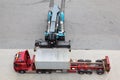 Crane moves and loads container to truck Royalty Free Stock Photo