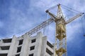 Crane near the under construction brick house Royalty Free Stock Photo