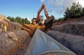 Crane operating over a trench constructing a pipeline -working in a confined space