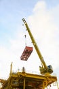 Crane operation transfer cargo on the platform and moving cargo from supply boat, heavy lift in oil and gas construction platform Royalty Free Stock Photo