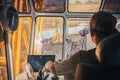 A crane operator controls heavy machinery at a coal loading dock located by the river, Royalty Free Stock Photo