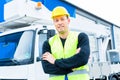 Crane operator in front of truck on site Royalty Free Stock Photo