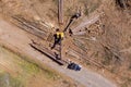 A crane operator loading logs being transported to a large truck from a newly felled timber trees Royalty Free Stock Photo