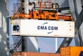 Crane operator unloading a refrigerated container from a cargo ship the Port of Rotterdam. The Netherlands - March 16, 2016 Royalty Free Stock Photo