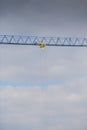 Crane over a construction site. Detail view of its arm. Buildings industry. Royalty Free Stock Photo