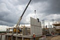 Crane placing precast concrete panels at building site Royalty Free Stock Photo