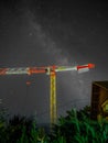 A crane by Potain with a milky way captured in the background Royalty Free Stock Photo