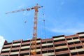 Crane and red brick residential building under construction Royalty Free Stock Photo