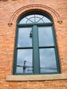 Crane reflection in a office building window