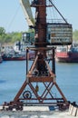 Crane in river port. Heavy cranes unloading metal to import. Steel delivery