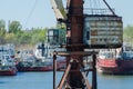 Crane in river port. Heavy cranes unloading metal to import. Steel delivery