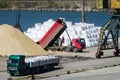 Crane in river port. Heavy cranes unloading metal to import. Steel delivery