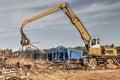 Crane in a salvage yard moving scrap metal Royalty Free Stock Photo