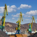 crane at the scrapyard in the seaport in Kamchatka Peninsula Royalty Free Stock Photo