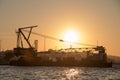 Crane ship docking in a port at sunset Royalty Free Stock Photo
