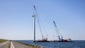 Crane ship lifting gondola for demolition offshore wind turbine farm Royalty Free Stock Photo