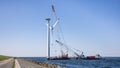 Crane ship lifting propeller for demolition offshore wind turbine farm Royalty Free Stock Photo
