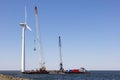 Crane ship lifting workers in gondola for demolition wind turbine Royalty Free Stock Photo