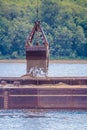 Crane on the ship produces sand on the river Royalty Free Stock Photo