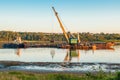 Crane on the ship produces sand on the river Royalty Free Stock Photo