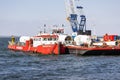 Crane ship and supply vessel busy with demolition offshore windturbine