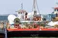 Crane ship and supply vessel busy with demolition offshore windturbine