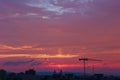 Crane silhouette in violet sunset sky in city Ceske Budejovice