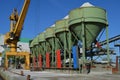 Crane and silos of a gravel plant on a pier Royalty Free Stock Photo