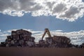 Crane stacking cubes of compressed metal at recycling center