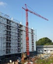 A crane stands in front of a building