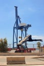 Crane and ton stacker crane working in the freight port managing the shipping containers