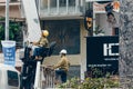 Crane truck on road for group of people working in Saigon,Vietnam, Vietnamese worker work on boom lift to cut branch of tree for