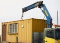 Crane truck unloading portable workers house container booth