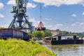 Crane unloading coal from barge to train wagon Royalty Free Stock Photo