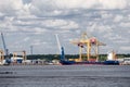 Crane unloads container ship in Moby Dik container terminal. Kronshtadt, Russia