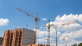 Crane and workers at construction site against blue sky Royalty Free Stock Photo
