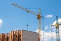 Crane and workers at construction site against blue sky Royalty Free Stock Photo