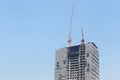 Crane working on a building under construction. Royalty Free Stock Photo