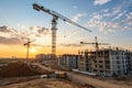 Crane working on construction site at sunset Royalty Free Stock Photo